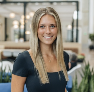 A woman in a black shirt, smiling.